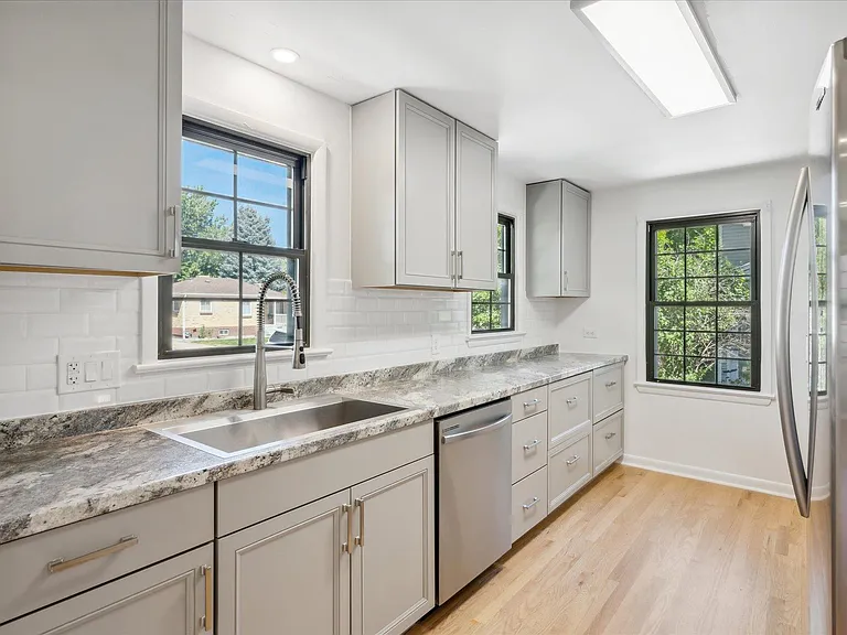 Kitchen Features Pot Drawers for Ease of Storage instead of Hard to Reach Lower Cabinets