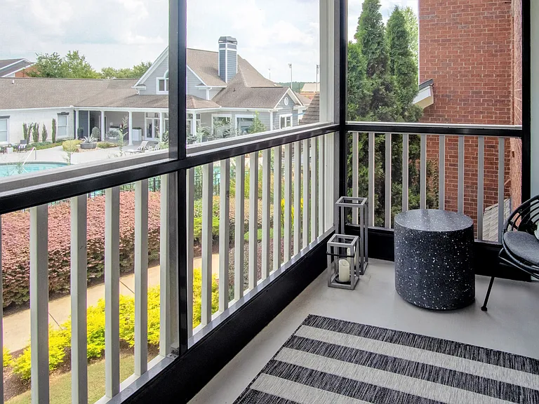 Embrace the fresh air and cozy comfort with our serene screened-in patios. (In select units)