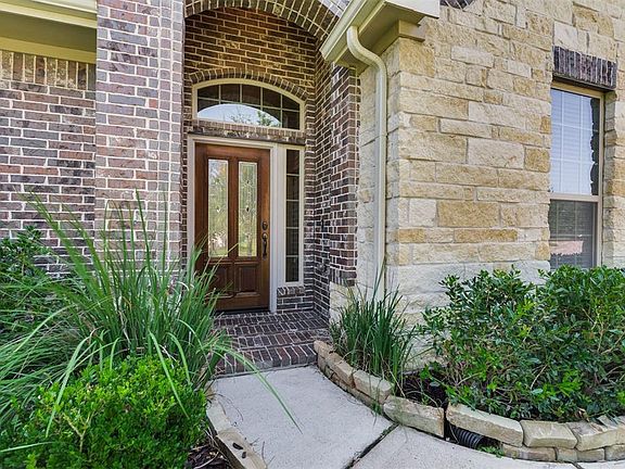 Inviting entry with mahogany leaded and beveled front door.