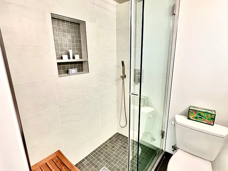Italian Tiled Shower & Floors w/Nook, Rain Shower System w/Handheld Shower Head, Heavy Duty Sliding Glass Shower Doors, Toto Toilet & Sink