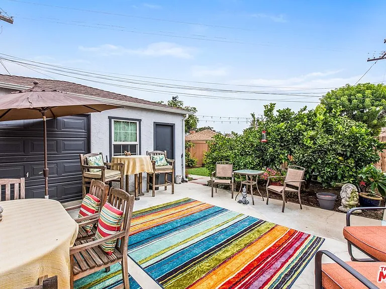 Other unit's backyard -- leads to shared garage storage and washer/dryer units