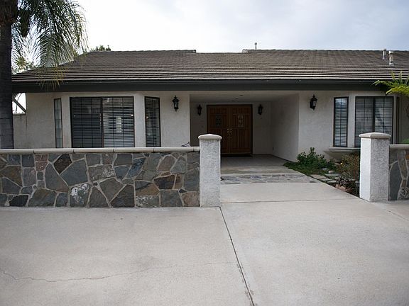 Entrance with two bay windows and double doors.
