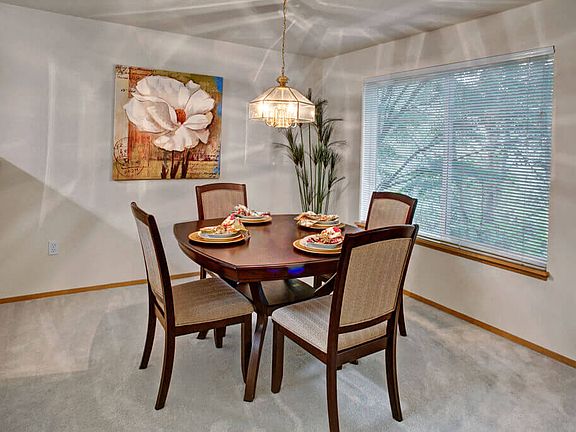 A cozy dining area off the kitchen with a large window and overhead lighting