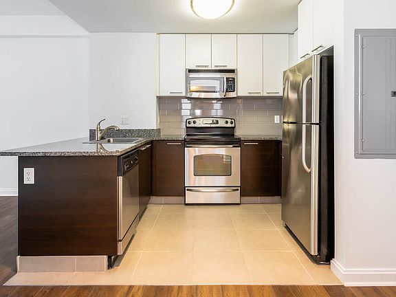 Kitchen with Stainless Steel Appliances, Granite Countertops and Hard Surface Flooring