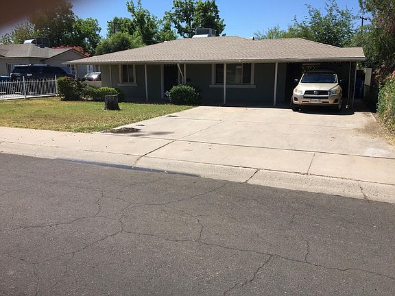 Front view of house. Carport parking and driveway parking