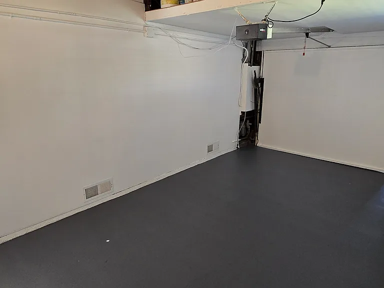 Remote control entry into garage with storage loft above.