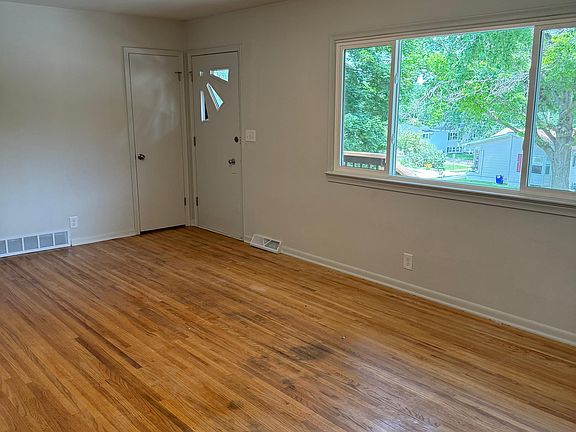 Living room facing the front door from the kitchen entry.