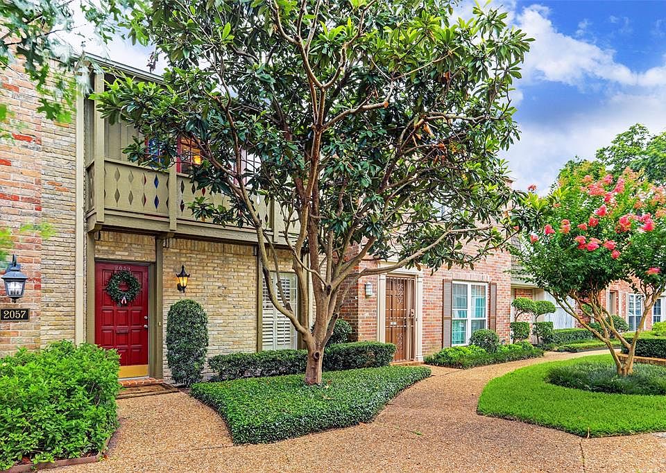 A view of the front entrance to your new home, an impeccably maintained front yard green space.