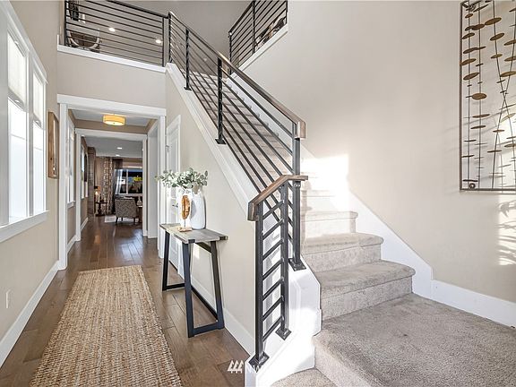 A light filled foyer, gorgeous metal rail, rich hardwood floors and tall ceilings welcome you as you enter.