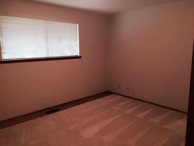 Rear bedroom with hardwood floors and large closet