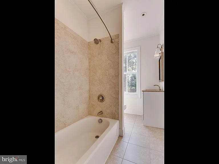 Full bath between sun room and back bedroom