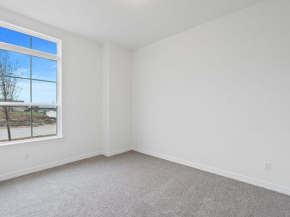 Your secondary bedroom features plush carpet, fresh paint, closet, and a large window that lets in p