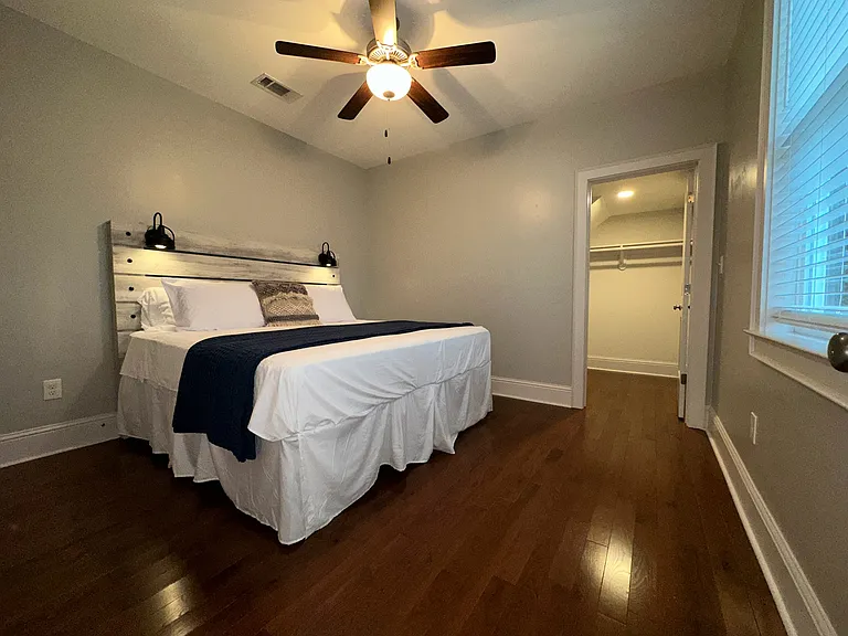 Bedroom. Large walk-in closet seen towards the right of the frame. There is also a second slightly smaller walk-in closet not pictured in the left of this frame.