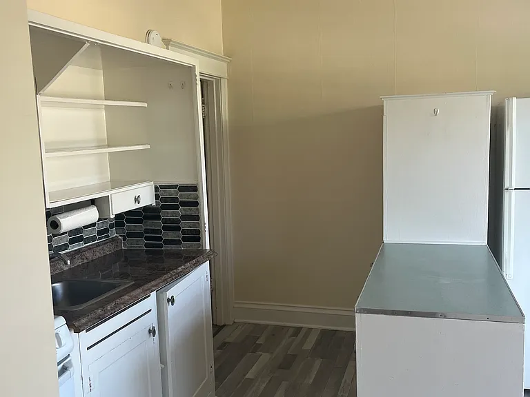 Kitchen leads to bathroom