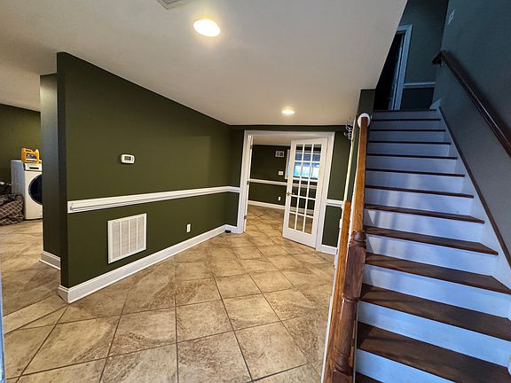entryway: 3rd bedroom straight ahead; large laundry room and storage to left
