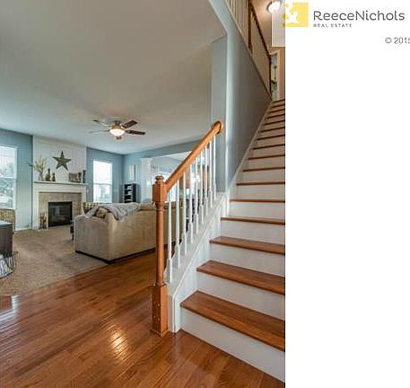 Gleaming hardwoods lead to carpeted living area