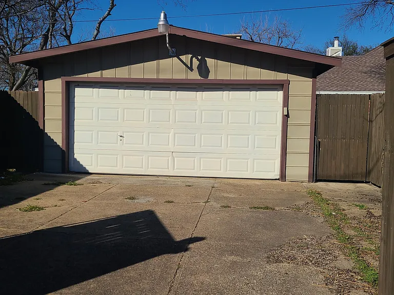carport with door closed includes automatic garage door opener