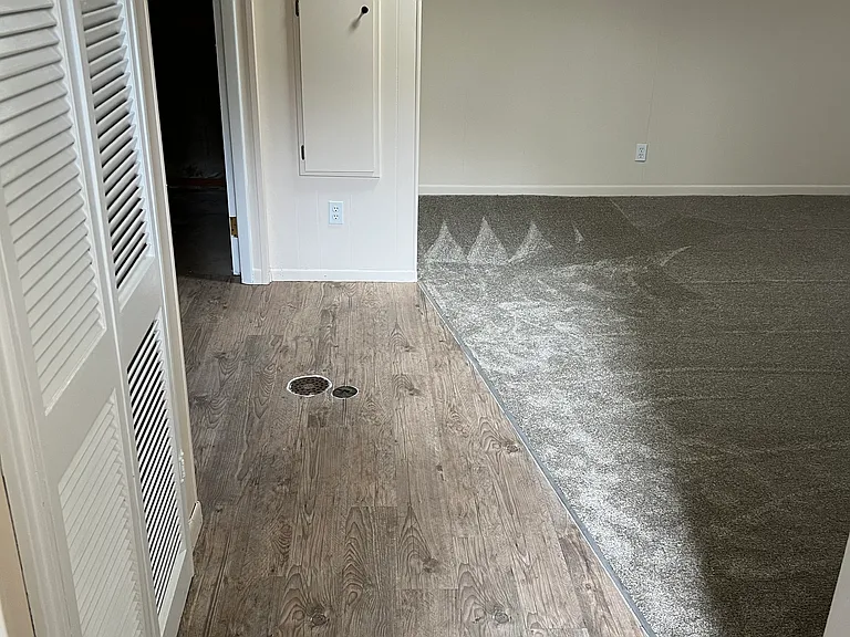 Downstairs walkway between family/media room and bathroom/storage room/utility room