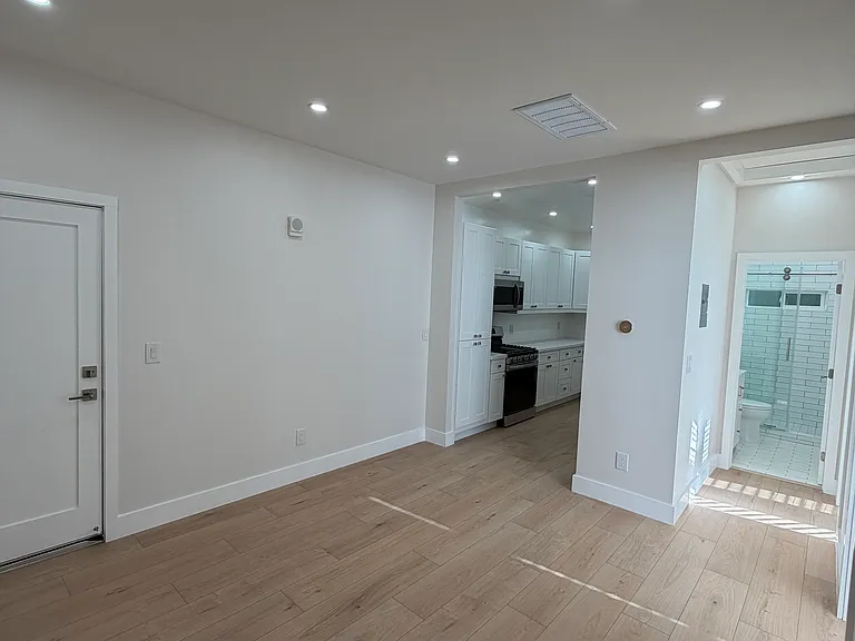 Living area looking int the kitchen and all new modern bathroom