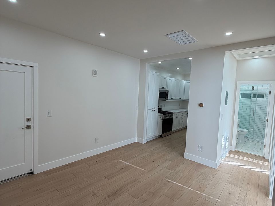 Living area looking int the kitchen and all new modern bathroom