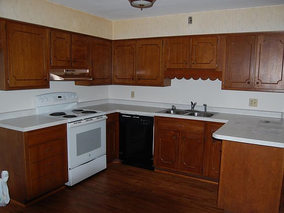 Kitchen. New counter top and vinyl wood flooring. Stove and dishwasher included.