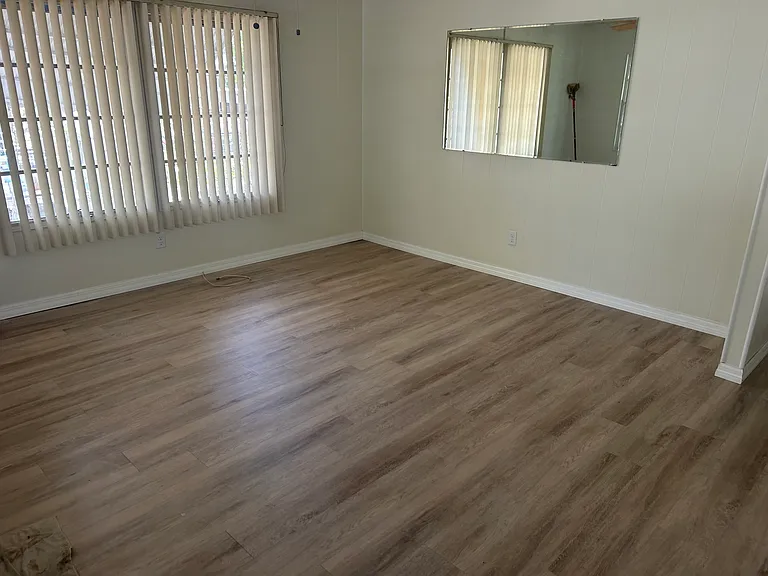 Living room has a ceiling fan.