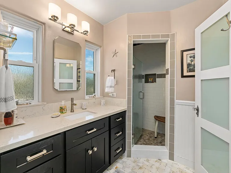 Full bathroom with walk-in shower and separate tub