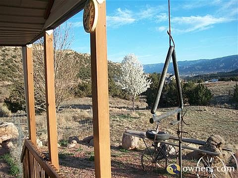 VIEW OUT FRONT PORCH & PLUM TREE & ANTIQUE WAGON