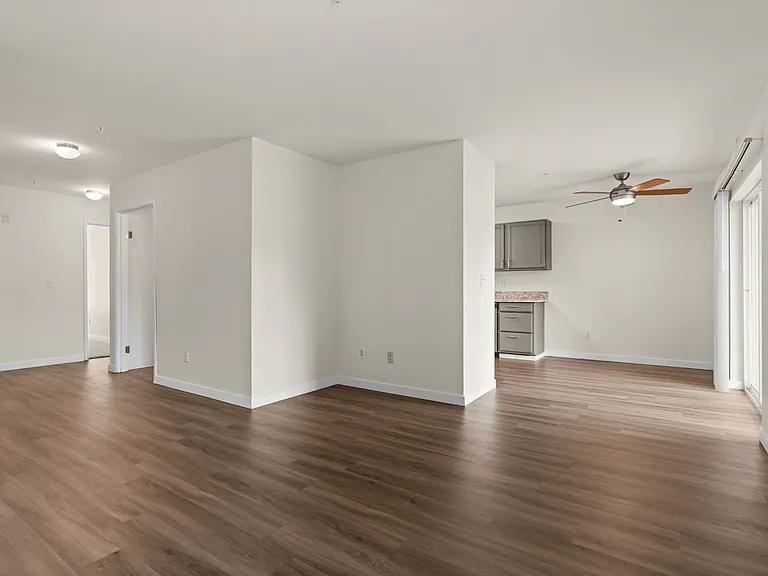 Open-concept living and dining area with wood-style flooring, natural light, and versatile space for entertaining or relaxing. Open-concept living and dining area with wood-style flooring, natural light, and versatile space for entertaining or relaxing.