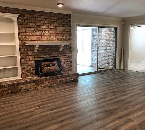family room with built-ins and f/p - slider leading out to screened-in patio