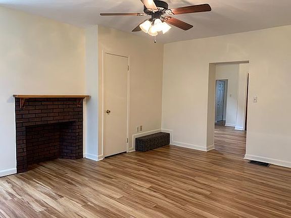 LR - first floor decorative fire place doorway into DR door: steps down to basement