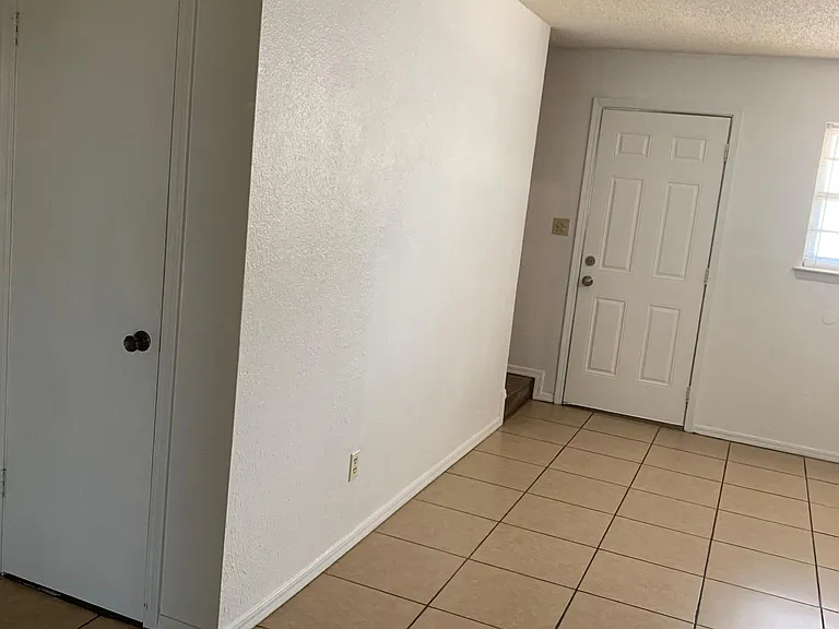 another view of the living room and the back door entrance.