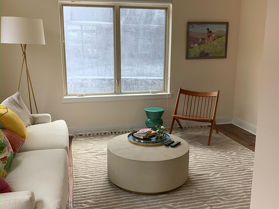 living room with one large window and two smaller windows providing lots of sunshine/light