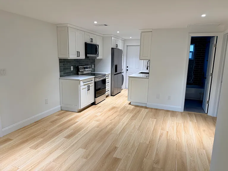 Kitchen and living room, looking onto the bathroom.