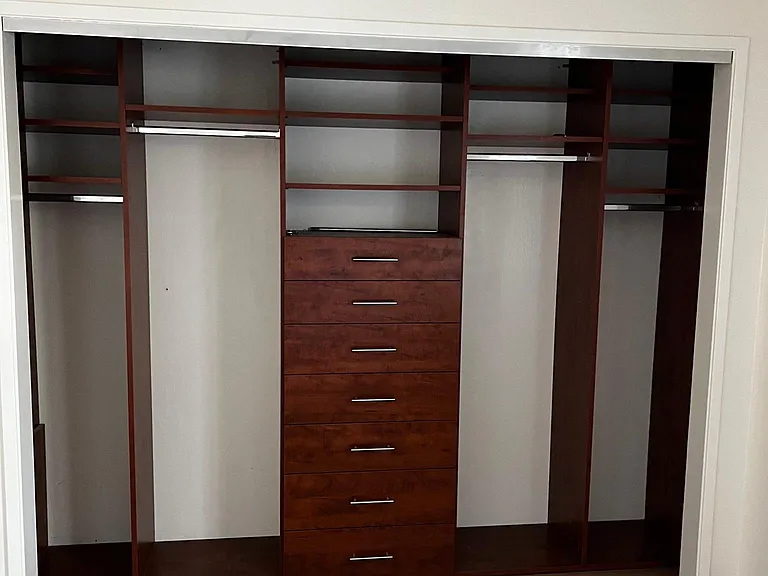 Custom closet organizing system with drawers in each bedroom