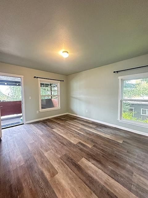 Main Living area with lots of windows and a huge front porch.