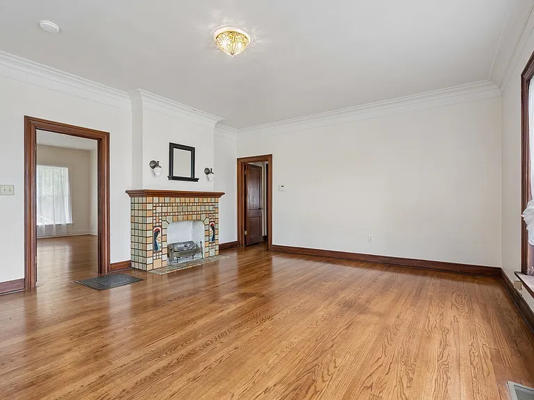 Living room looking toward transition room to formal dining room door on right and bedroom 1 door on left