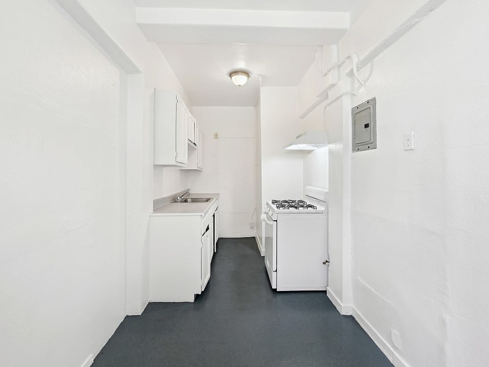 Union a long white kitchen with white appliances and white cabinets