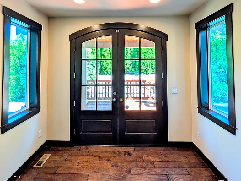 Solid wood French door opens into covered wood patio