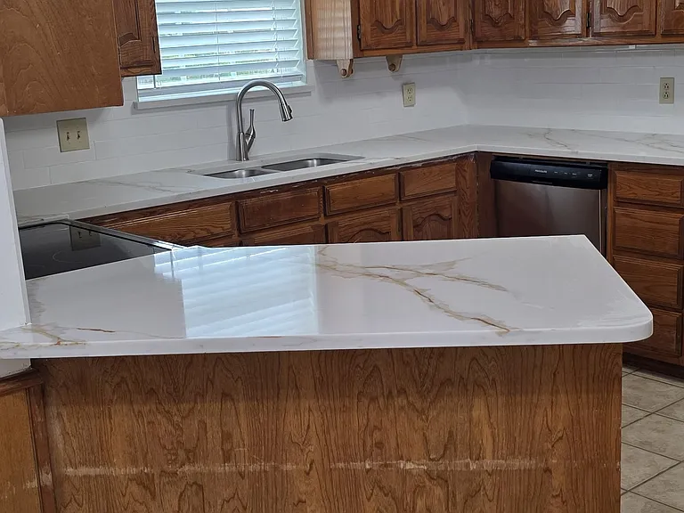 large spacious kitchen with lots of cabinets, new quartz counters, ice maker line.