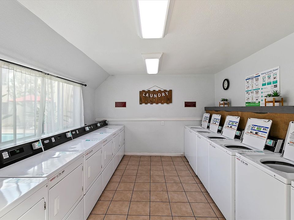 Well-maintained laundry room with six coinless-operated washers and six dryers