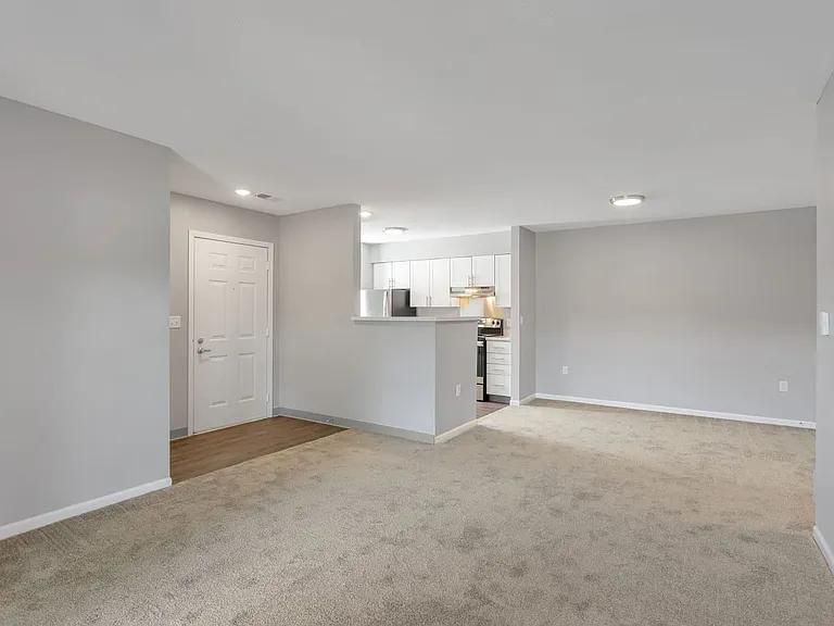 Spacious living areas with plush carpeting and abundant natural light create a warm, inviting atmosphere, professionally managed by Highlands Vista Group.