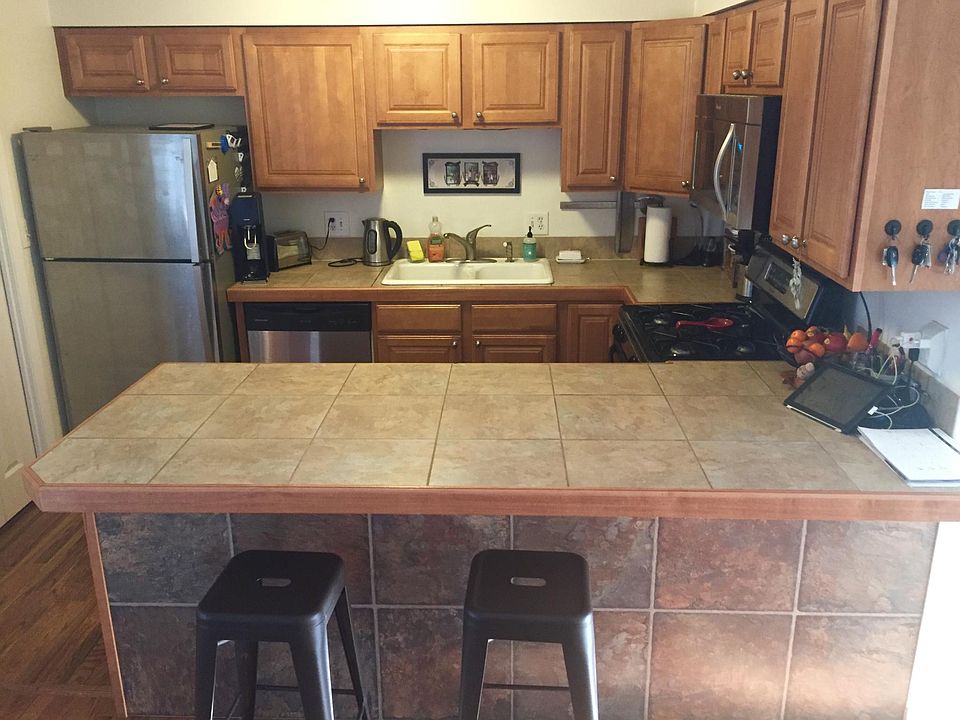 Eat in kitchen with tiled bar area, hardwood flooring, stainless steel appliances, gas stove and built in microwave oven. Full size washer and dryer.