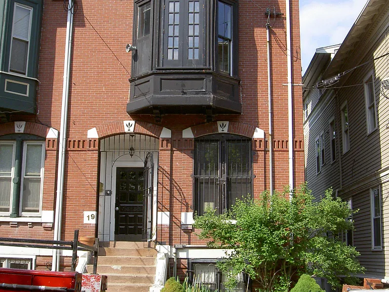 the apartment is on the ground floor behind the plantings
