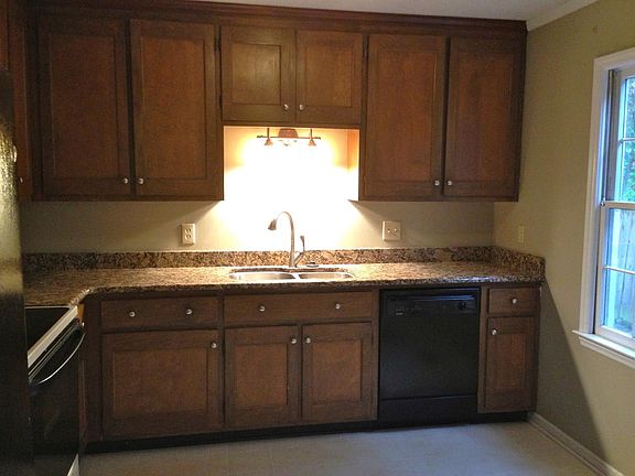 Kitchen with granite counters. Dishwasher, stove/oven, micr
