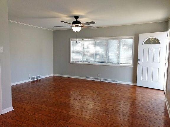Living room with bay window and hardwood floor.