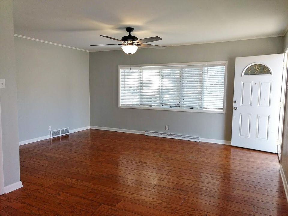 Living room with bay window and hardwood floor.