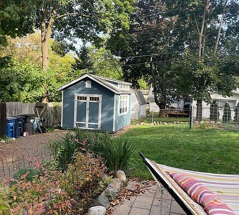 View from back patio to shed and recycling carts