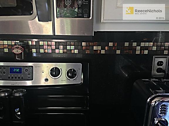 Modern glass mini tiles on backsplash in kitchen