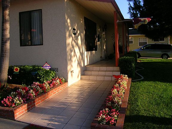 Tiled entry and flower beds